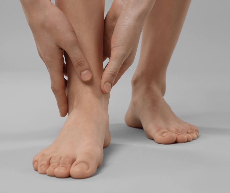 person holding foot in pain
