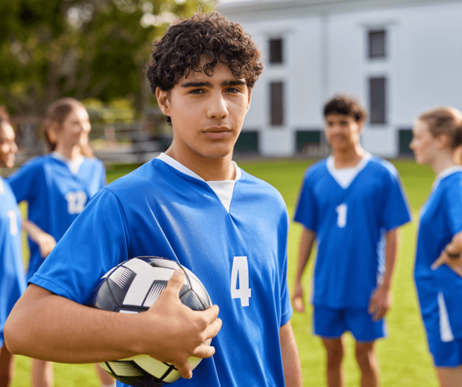teenager holding a soccer ball
