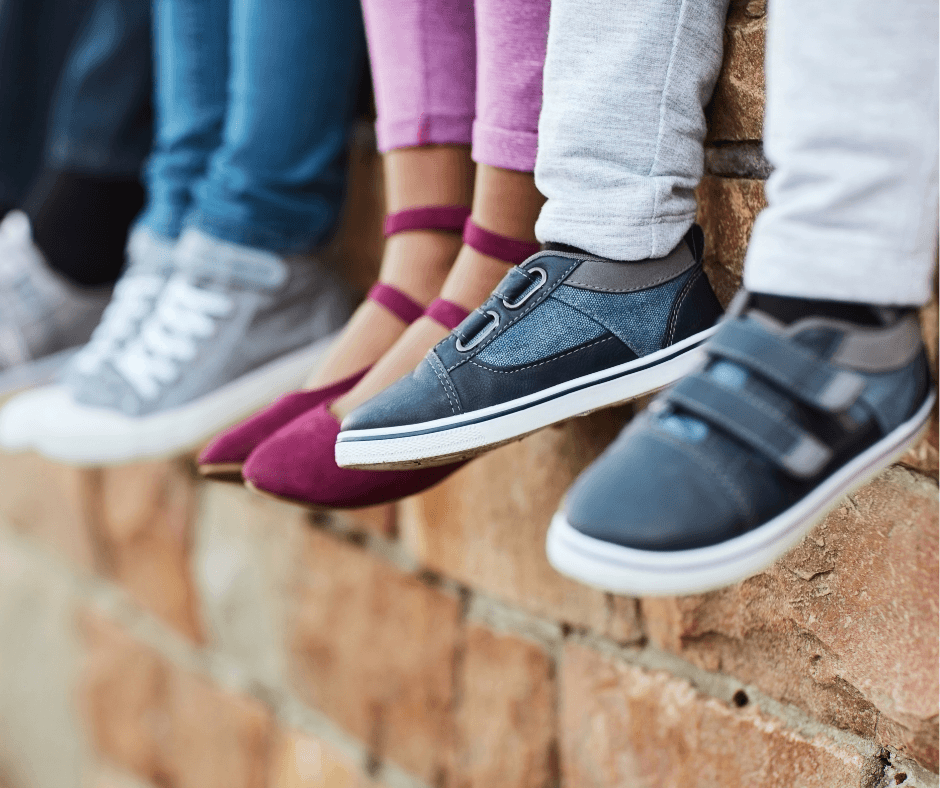 kids feet on brick wall